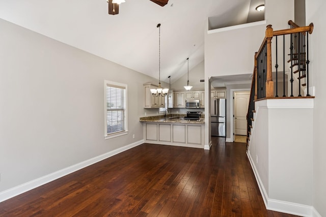 1037 Irish Way, Spring Hill, TN 37174 - kitchen featuring appliances with stainless steel finishes, cream cabinetry, a peninsula, dark wood finished floors, and a chandelier
