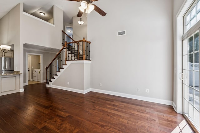 1037 Irish Way, Spring Hill, TN 37174 - unfurnished living room featuring a high ceiling, washer and dryer, stairway, hardwood / wood-style floors, and a ceiling fan