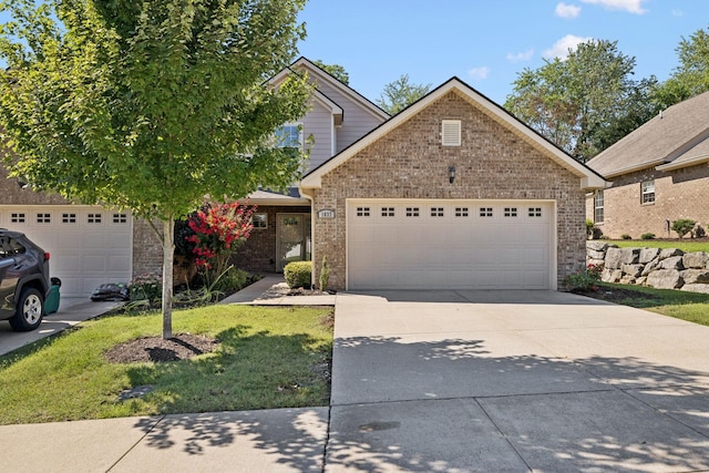 1037 Irish Way, Spring Hill, TN 37174 - view of front of property featuring driveway, a garage, a front yard, and brick siding