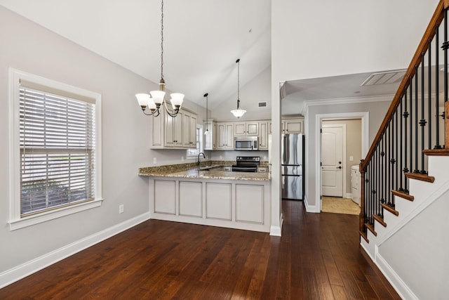 1037 Irish Way, Spring Hill, TN 37174 - kitchen with stainless steel appliances, a peninsula, a chandelier, dark wood finished floors, and light stone countertops