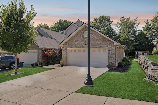 1037 Irish Way, Spring Hill, TN 37174 - view of front of home with driveway, an attached garage, a yard, and brick siding