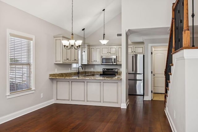 1037 Irish Way, Spring Hill, TN 37174 - kitchen featuring stainless steel appliances, cream cabinetry, a peninsula, a chandelier, and lofted ceiling