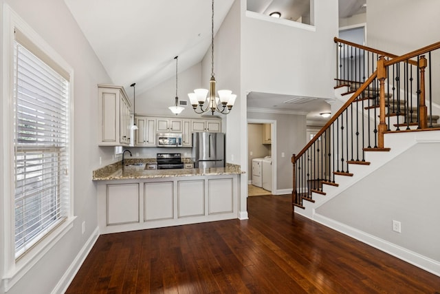 1037 Irish Way, Spring Hill, TN 37174 - kitchen with appliances with stainless steel finishes, washing machine and clothes dryer, a chandelier, dark wood-type flooring, and high vaulted ceiling
