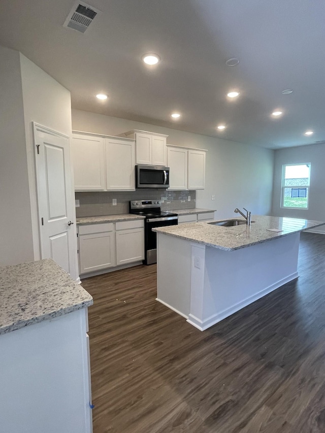 462 Jet Stream Dr, La Vergne, TN 37086 - kitchen featuring stainless steel appliances, dark wood-style floors, white cabinetry, a center island with sink, and recessed lighting