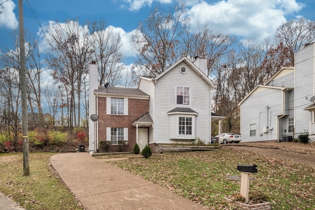 954 Strand Fleet Dr, Antioch, TN 37013 - traditional-style home with a chimney, driveway, brick siding, and a front lawn