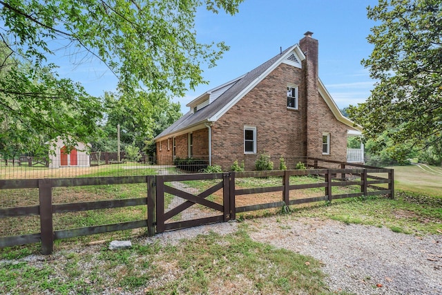 3035 Culleoka Hwy, Culleoka, TN 38451 - view of home's exterior with brick siding, a chimney, a fenced front yard, and a gate