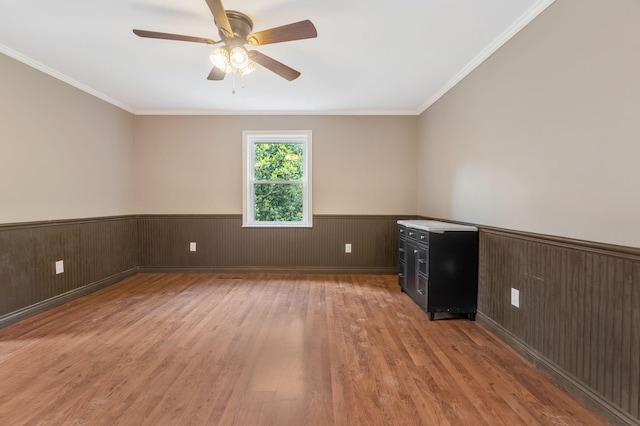 3035 Culleoka Hwy, Culleoka, TN 38451 - empty room with light wood-style floors, wainscoting, ceiling fan, ornamental molding, and wood walls