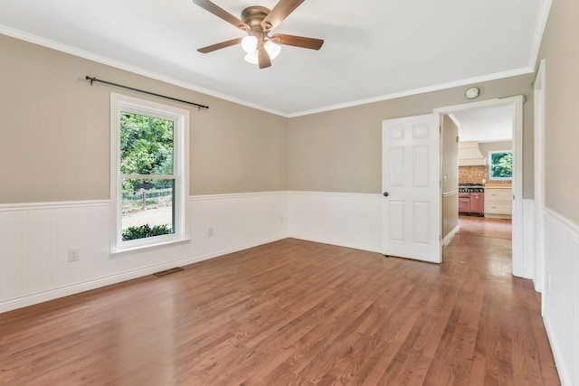 3035 Culleoka Hwy, Culleoka, TN 38451 - spare room featuring a wainscoted wall, a ceiling fan, wood finished floors, and ornamental molding
