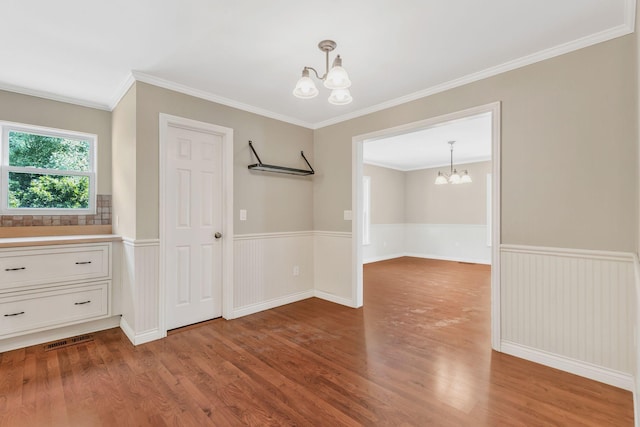 3035 Culleoka Hwy, Culleoka, TN 38451 - unfurnished dining area with a chandelier, wood finished floors, a wainscoted wall, and ornamental molding