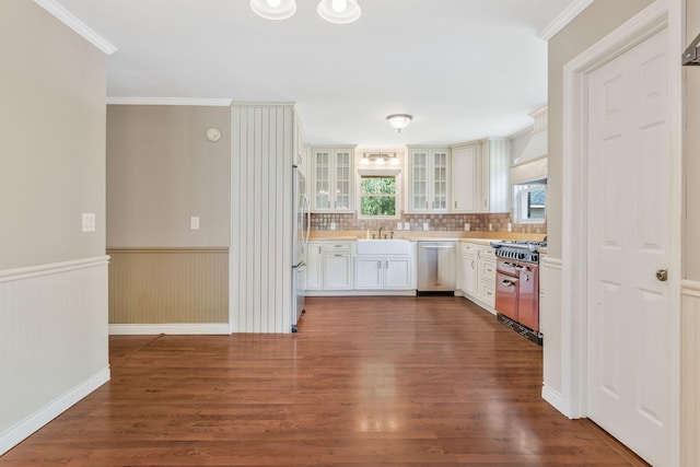 3035 Culleoka Hwy, Culleoka, TN 38451 - kitchen with appliances with stainless steel finishes, dark wood-type flooring, glass insert cabinets, light countertops, and wainscoting
