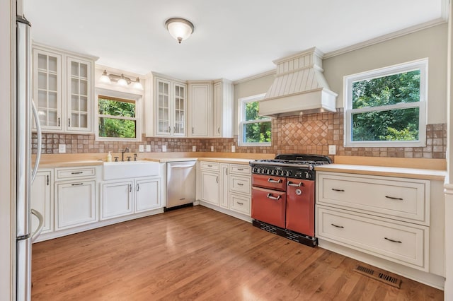 3035 Culleoka Hwy, Culleoka, TN 38451 - kitchen featuring stainless steel appliances, premium range hood, light countertops, light wood-style flooring, and backsplash