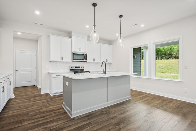 1922 Hildebrand Ln, Columbia, TN 38401 - kitchen featuring stainless steel microwave, range with electric cooktop, backsplash, dark wood-style flooring, and light countertops