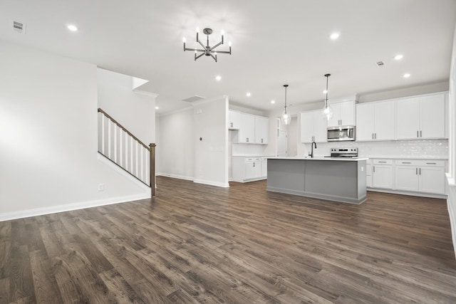 1922 Hildebrand Ln, Columbia, TN 38401 - kitchen with stainless steel microwave, recessed lighting, a chandelier, dark wood finished floors, and white cabinets