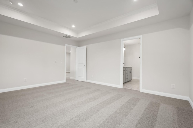 1922 Hildebrand Ln, Columbia, TN 38401 - unfurnished bedroom with ornamental molding, a raised ceiling, light colored carpet, recessed lighting, and connected bathroom