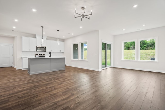 1922 Hildebrand Ln, Columbia, TN 38401 - kitchen with stainless steel microwave, dark wood-type flooring, healthy amount of natural light, an island with sink, and recessed lighting