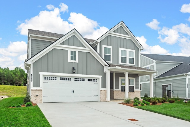 1922 Hildebrand Ln, Columbia, TN 38401 - view of front of home featuring board and batten siding, brick siding, driveway, and a front lawn