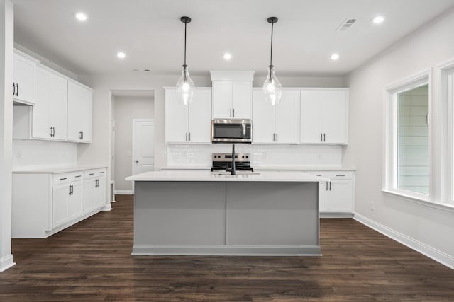 1922 Hildebrand Ln, Columbia, TN 38401 - kitchen with appliances with stainless steel finishes, backsplash, dark wood finished floors, recessed lighting, and a kitchen island with sink