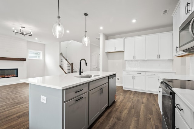 1922 Hildebrand Ln, Columbia, TN 38401 - kitchen featuring appliances with stainless steel finishes, gray cabinets, open floor plan, dark wood finished floors, and light countertops