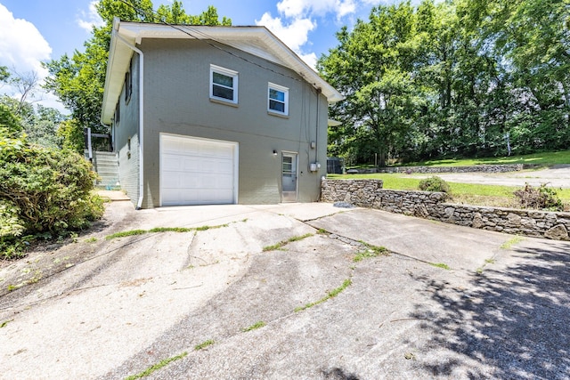 528 Maple St, Pulaski, TN 38478 - view of home's exterior featuring concrete driveway, a garage, and brick siding
