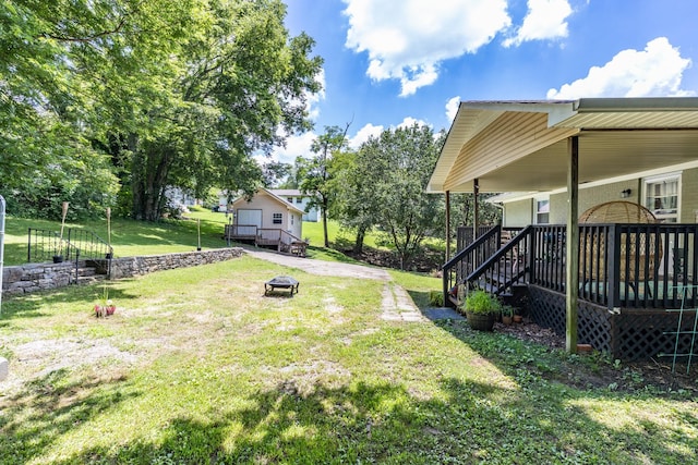 528 Maple St, Pulaski, TN 38478 - view of grassy yard with an outdoor fire pit and a wooden deck