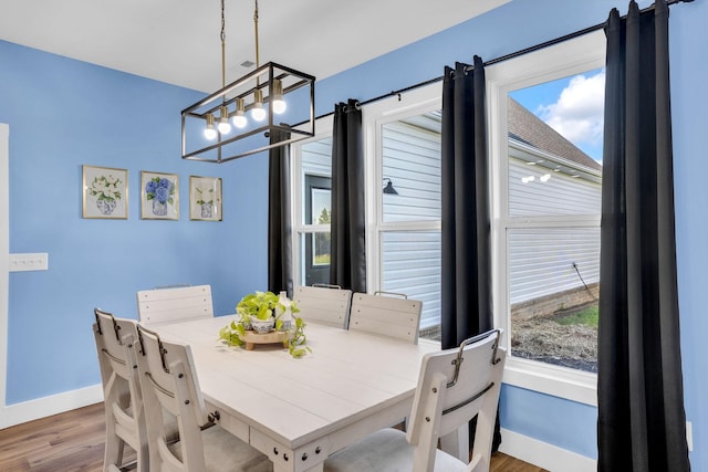 426 Maple Bend Rd, Winchester, TN 37398 - dining area with wood finished floors, a chandelier, and plenty of natural light