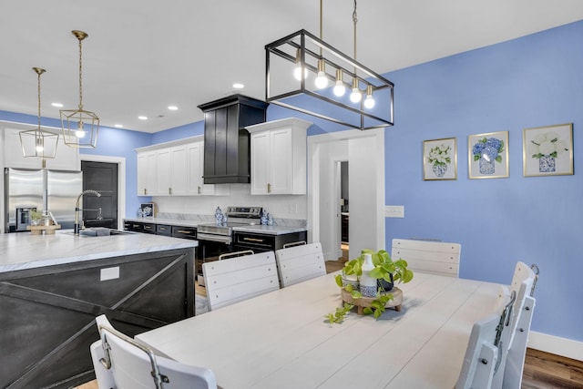 426 Maple Bend Rd, Winchester, TN 37398 - kitchen with stainless steel appliances, light countertops, white cabinetry, backsplash, and recessed lighting