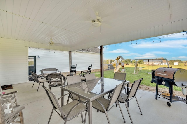 426 Maple Bend Rd, Winchester, TN 37398 - view of patio featuring a playground, outdoor dining space, ceiling fan, and a grill