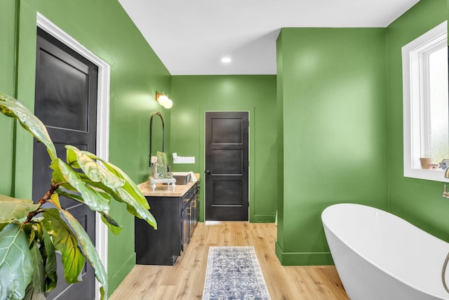 426 Maple Bend Rd, Winchester, TN 37398 - full bathroom featuring vanity, a freestanding bath, and wood finished floors
