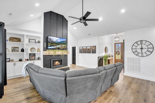426 Maple Bend Rd, Winchester, TN 37398 - living area with high vaulted ceiling, a fireplace, ceiling fan, light wood finished floors, and a chandelier