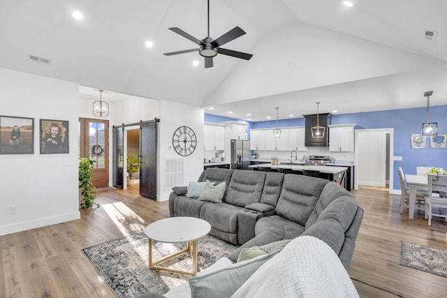 426 Maple Bend Rd, Winchester, TN 37398 - living area with a barn door, high vaulted ceiling, recessed lighting, a ceiling fan, and light wood finished floors