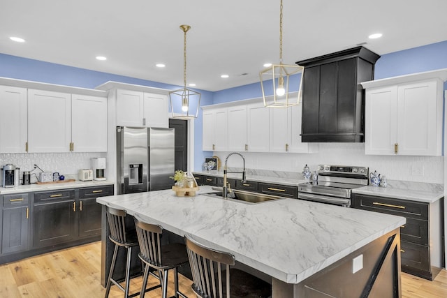 426 Maple Bend Rd, Winchester, TN 37398 - kitchen with stainless steel appliances, white cabinets, light wood-style floors, backsplash, and pendant lighting