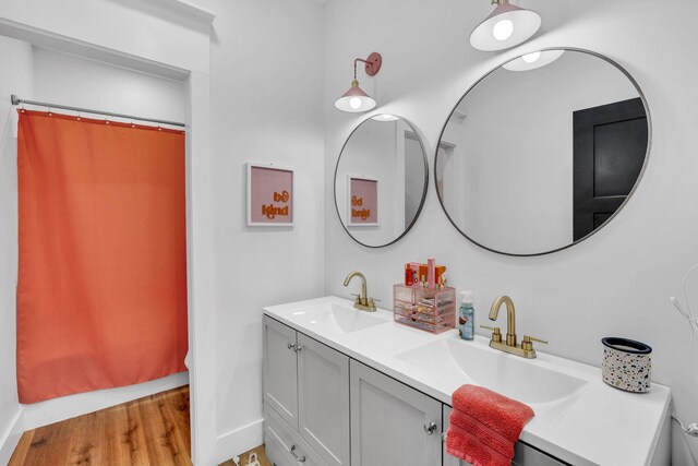 426 Maple Bend Rd, Winchester, TN 37398 - full bath with double vanity, wood finished floors, and a shower with shower curtain