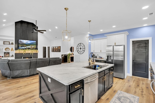 426 Maple Bend Rd, Winchester, TN 37398 - kitchen featuring appliances with stainless steel finishes, white cabinets, light countertops, ceiling fan, and light wood finished floors
