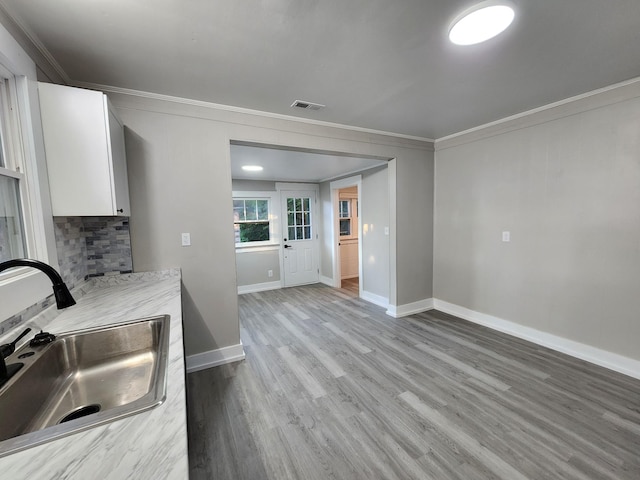 810 Lynwood St, Winchester, TN 37398 - kitchen featuring crown molding, white cabinets, wood finished floors, and light countertops