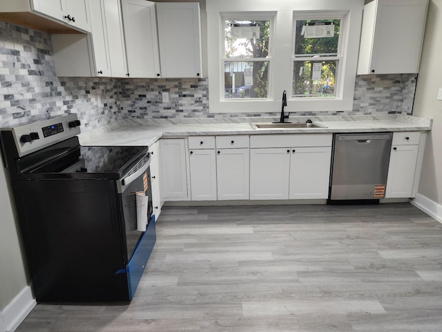 810 Lynwood St, Winchester, TN 37398 - kitchen featuring range with electric cooktop, stainless steel dishwasher, tasteful backsplash, light wood-type flooring, and white cabinets