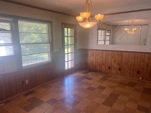 320 Shepherd Hills Dr, Madison, TN 37115 - unfurnished dining area with a chandelier, tile patterned floors, a wainscoted wall, wooden walls, and crown molding