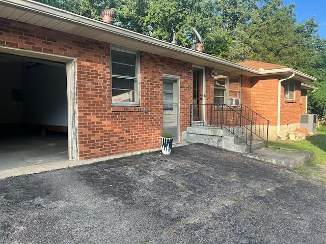 320 Shepherd Hills Dr, Madison, TN 37115 - view of front of house featuring brick siding, an attached garage, and asphalt driveway