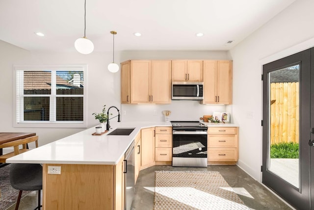 1823 River Dr, Nashville, TN 37218 - kitchen with light brown cabinets, appliances with stainless steel finishes, a peninsula, light countertops, and recessed lighting