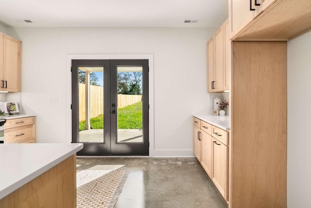 1823 River Dr, Nashville, TN 37218 - kitchen featuring french doors, light brown cabinets, finished concrete flooring, and light countertops