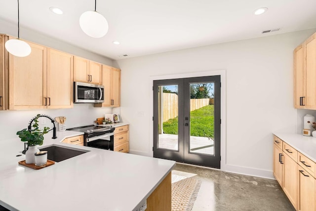 1823 River Dr, Nashville, TN 37218 - kitchen with stainless steel appliances, light brown cabinets, french doors, light countertops, and recessed lighting
