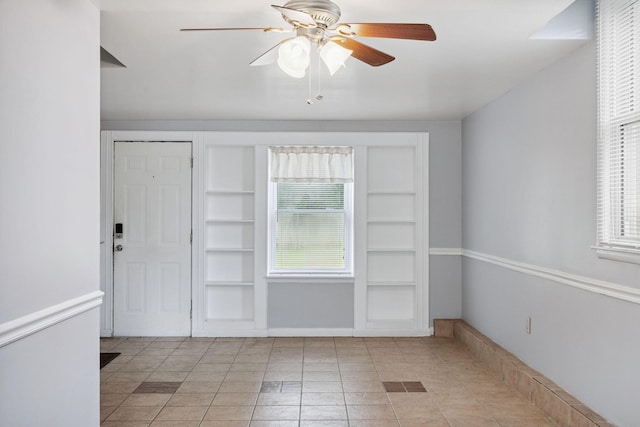 2311 Mayfair Ave, Murfreesboro, TN 37130 - unfurnished room with built in shelves, ceiling fan, and light tile patterned floors