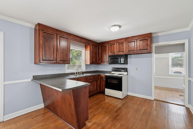 2311 Mayfair Ave, Murfreesboro, TN 37130 - kitchen with range with electric cooktop, black microwave, a peninsula, dark countertops, and wood finished floors