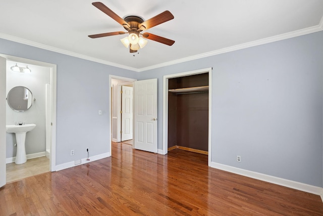 2311 Mayfair Ave, Murfreesboro, TN 37130 - unfurnished bedroom with ornamental molding, wood finished floors, a closet, connected bathroom, and ceiling fan