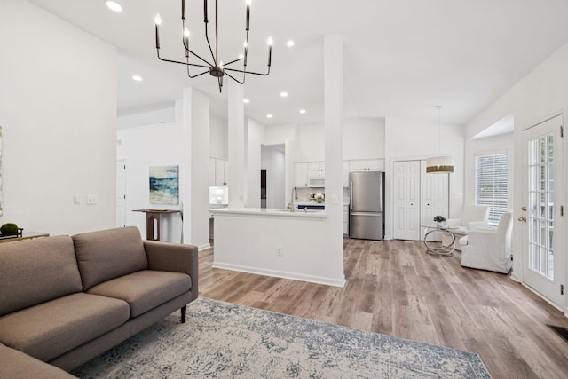 201 Hideaway Trl, Franklin, TN 37069 - living area featuring a chandelier, light wood-style flooring, a towering ceiling, and recessed lighting