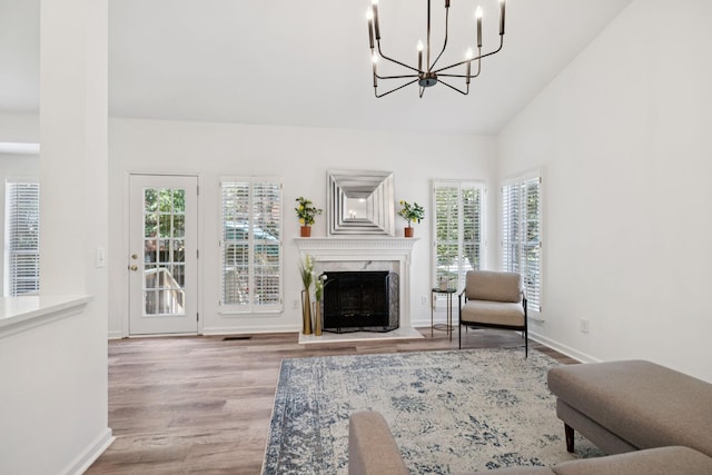 201 Hideaway Trl, Franklin, TN 37069 - living area with a chandelier, wood finished floors, vaulted ceiling, and a premium fireplace