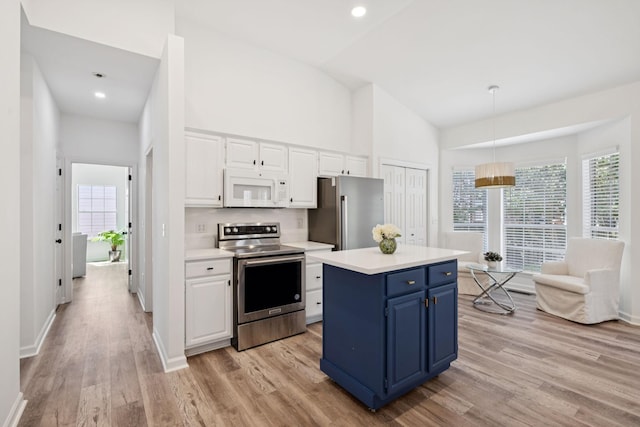 201 Hideaway Trl, Franklin, TN 37069 - kitchen with stainless steel appliances, blue cabinets, white cabinetry, a center island, and plenty of natural light