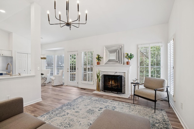 201 Hideaway Trl, Franklin, TN 37069 - living area with wood finished floors, a chandelier, a fireplace, and high vaulted ceiling