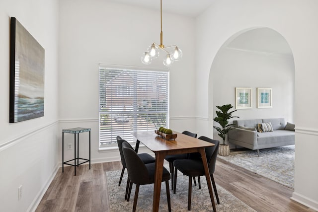 201 Hideaway Trl, Franklin, TN 37069 - dining area featuring a chandelier, wood finished floors, and arched walkways