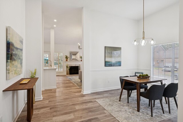 201 Hideaway Trl, Franklin, TN 37069 - dining room featuring a chandelier, wood finished floors, a fireplace, and recessed lighting
