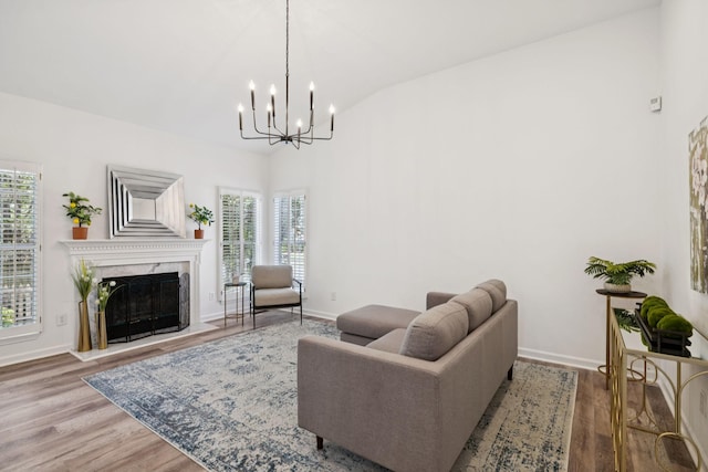 201 Hideaway Trl, Franklin, TN 37069 - living area featuring vaulted ceiling, a chandelier, plenty of natural light, wood finished floors, and a high end fireplace